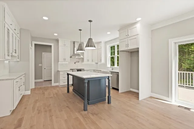 a kitchen with kitchen island a sink stove and refrigerator
