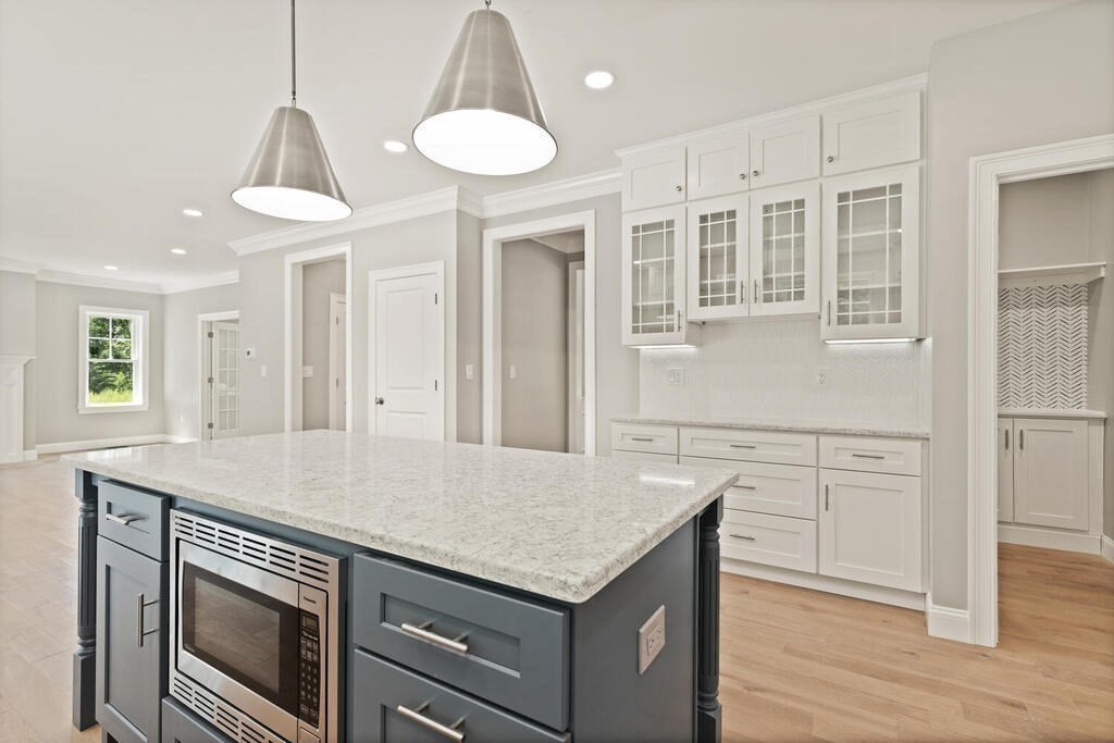 15 Lawler Lane Stoughton, MA 02072 - Photo 14 of 41 a kitchen with stainless steel appliances granite countertop a kitchen island a stove and a sink