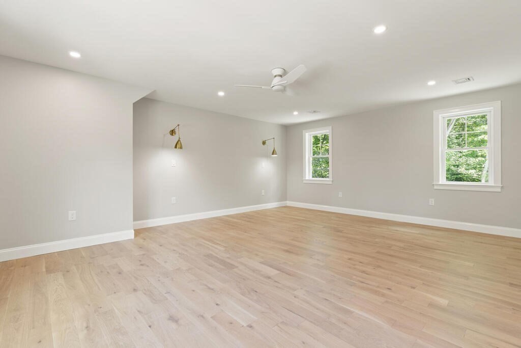 15 Lawler Lane Stoughton, MA 02072 - Photo 26 of 41 an empty room with wooden floor and windows
