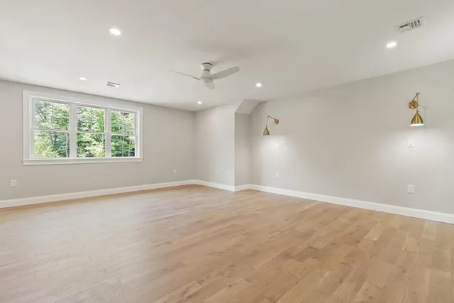 an empty room with windows and closet
