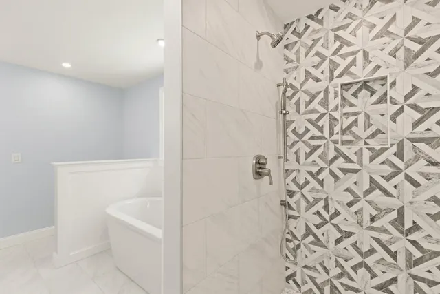 a bathroom with a bathtub and shower