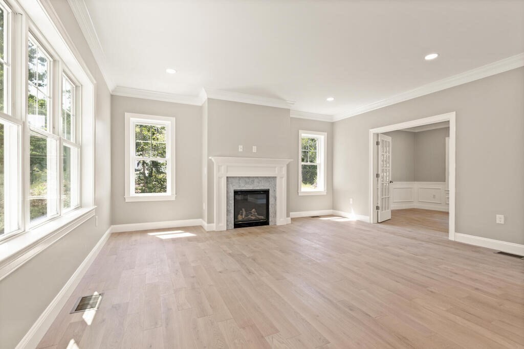 15 Lawler Lane Stoughton, MA 02072 - Photo 4 of 41 a view of an empty room with a window and fireplace