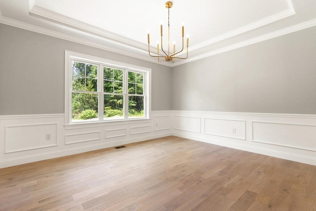 15 Lawler Lane Stoughton, MA 02072 - Photo 6 of 41 a view of empty room with wooden floor and fan