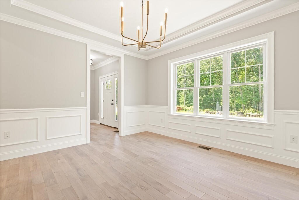 15 Lawler Lane Stoughton, MA 02072 - Photo 7 of 41 an empty room with wooden floor cabinet and windows