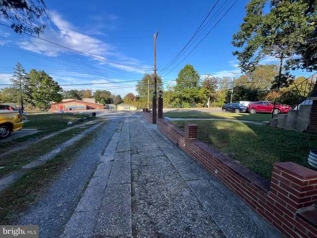 a view of a yard with wooden fence