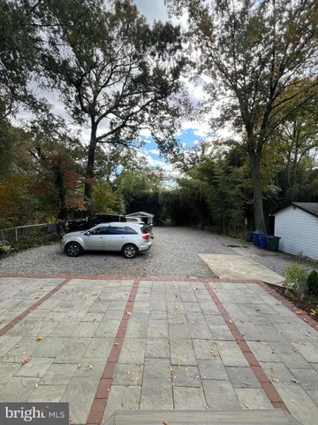 a view of backyard with parked car