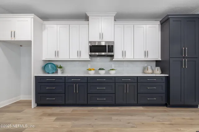 a kitchen with stainless steel appliances granite countertop a large cabinets and a stove