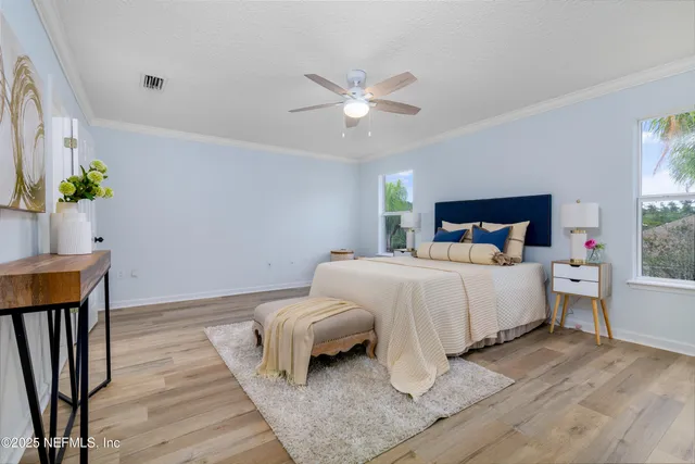 a bedroom with a bed and a potted plant