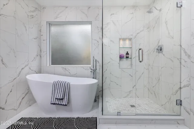 a bathroom with a bathtub and shower