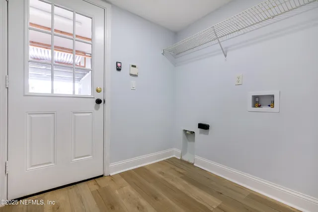 a view of room with hardwood floor and window