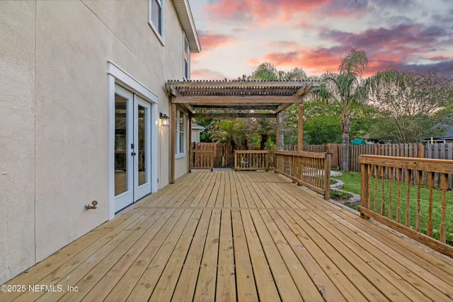a view of outdoor space with wooden floor and fence