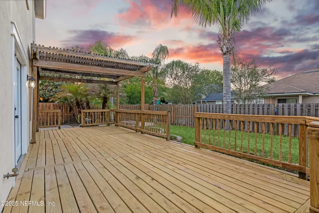 a view of a wooden deck with a yard