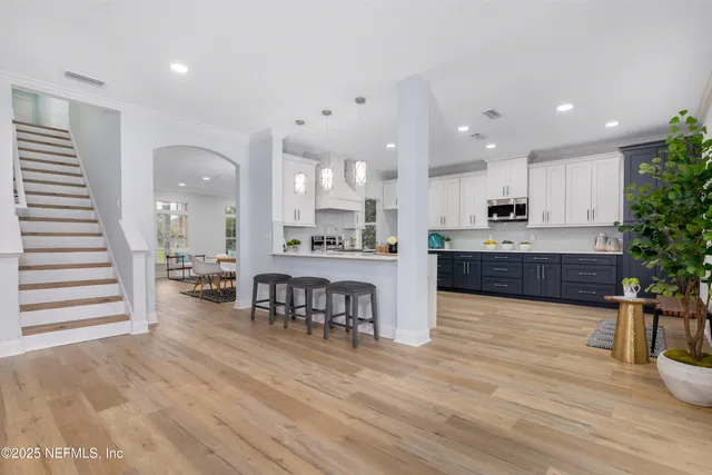 an open kitchen with kitchen island and stainless steel appliances