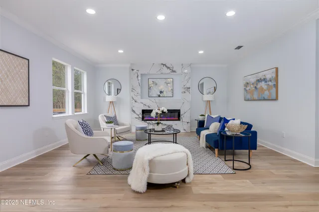 a living room with furniture and wooden floor