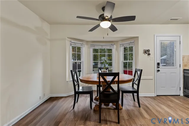 a view of a dining room with furniture and wooden floor