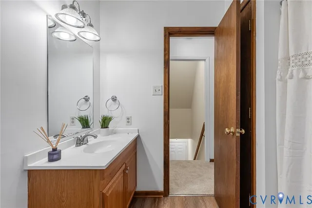 a bathroom with a sink vanity and a mirror