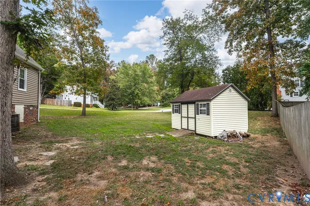 a view of a house with yard and a tree