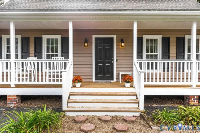 a front view of a house with a window and chair