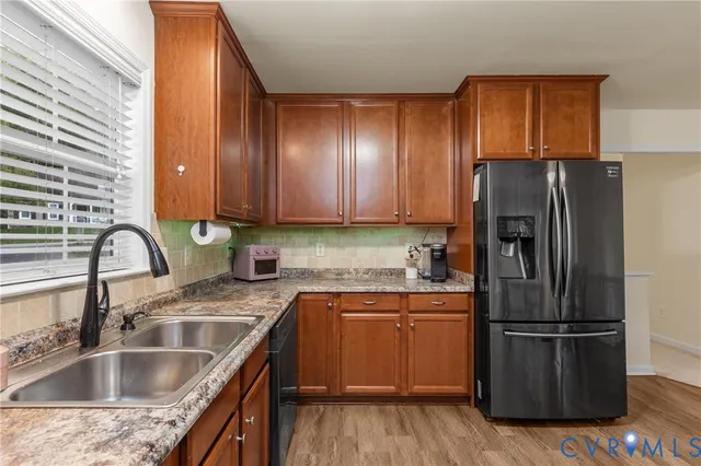 a kitchen with a sink cabinets and stainless steel appliances