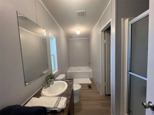 a bathroom with a sink vanity granite and a mirror