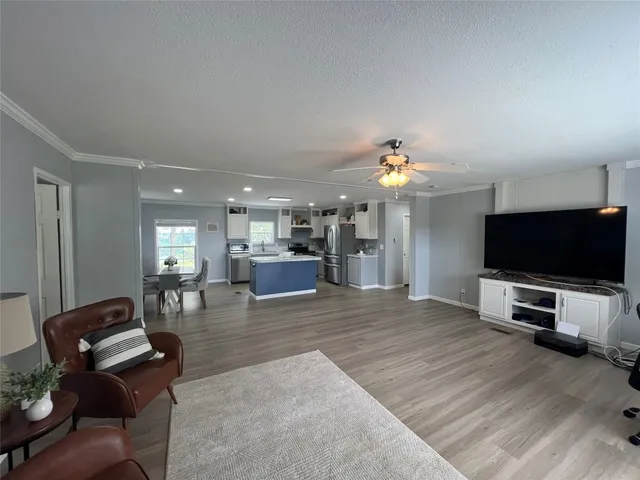 a view of a livingroom with furniture and a flat screen tv