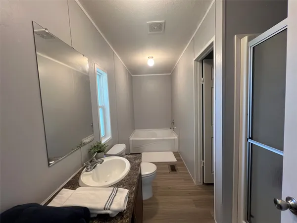 a bathroom with a sink vanity granite and a mirror