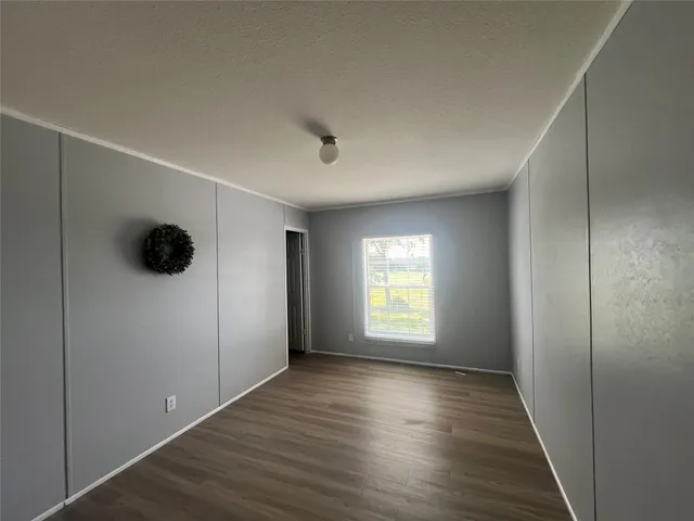 a view of a patio with table and chairs a barbeque with wooden floor and fence