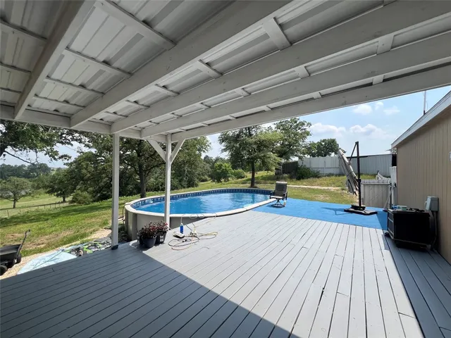 a view of a swimming pool with a patio