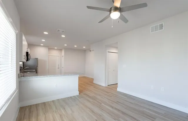 a view of a kitchen and a chandelier fan