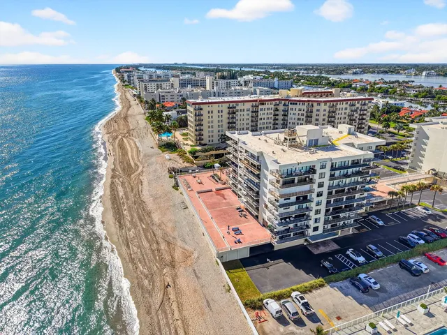 a view of a building with a swimming pool and sitting area