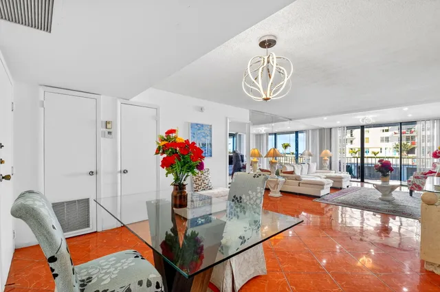 a living room with furniture and flowers