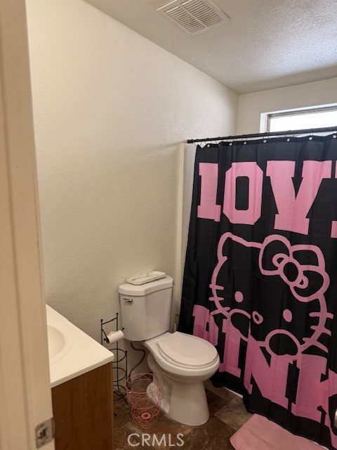 24260 Minton Road Homeland, CA 92548 - Photo 11 of 23 a bathroom with a toilet and a shower curtain