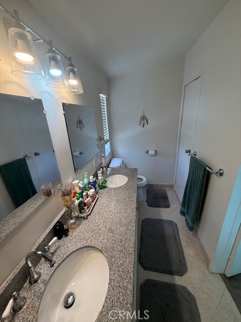 24260 Minton Road Homeland, CA 92548 - Photo 16 of 23 a bathroom with a granite countertop sink and mirror wooden cabinet
