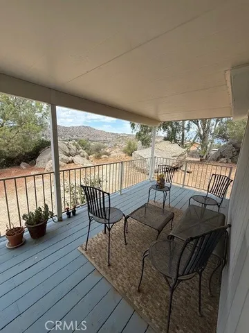 a view of a balcony dining area with furniture