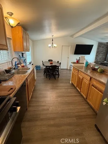a kitchen with sink stove and cabinets