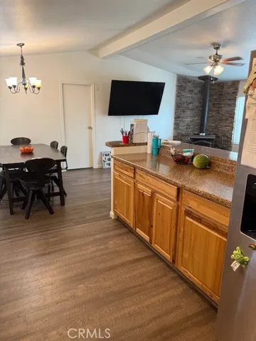 a kitchen with stainless steel appliances granite countertop a sink counter space and a view of living room