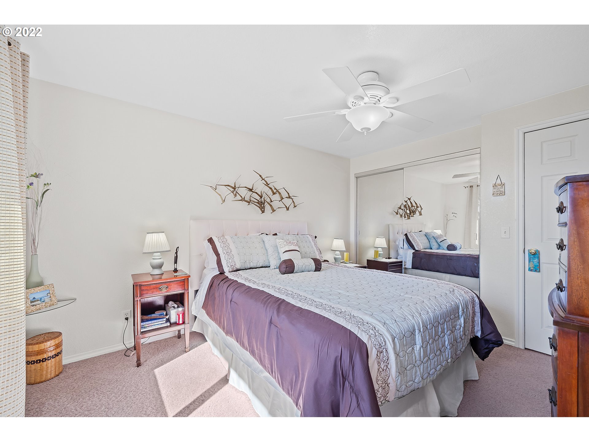 4225 Orchard Loop Netarts, OR 97141 - Photo 16 of 31 a bedroom with a bed and a chandelier