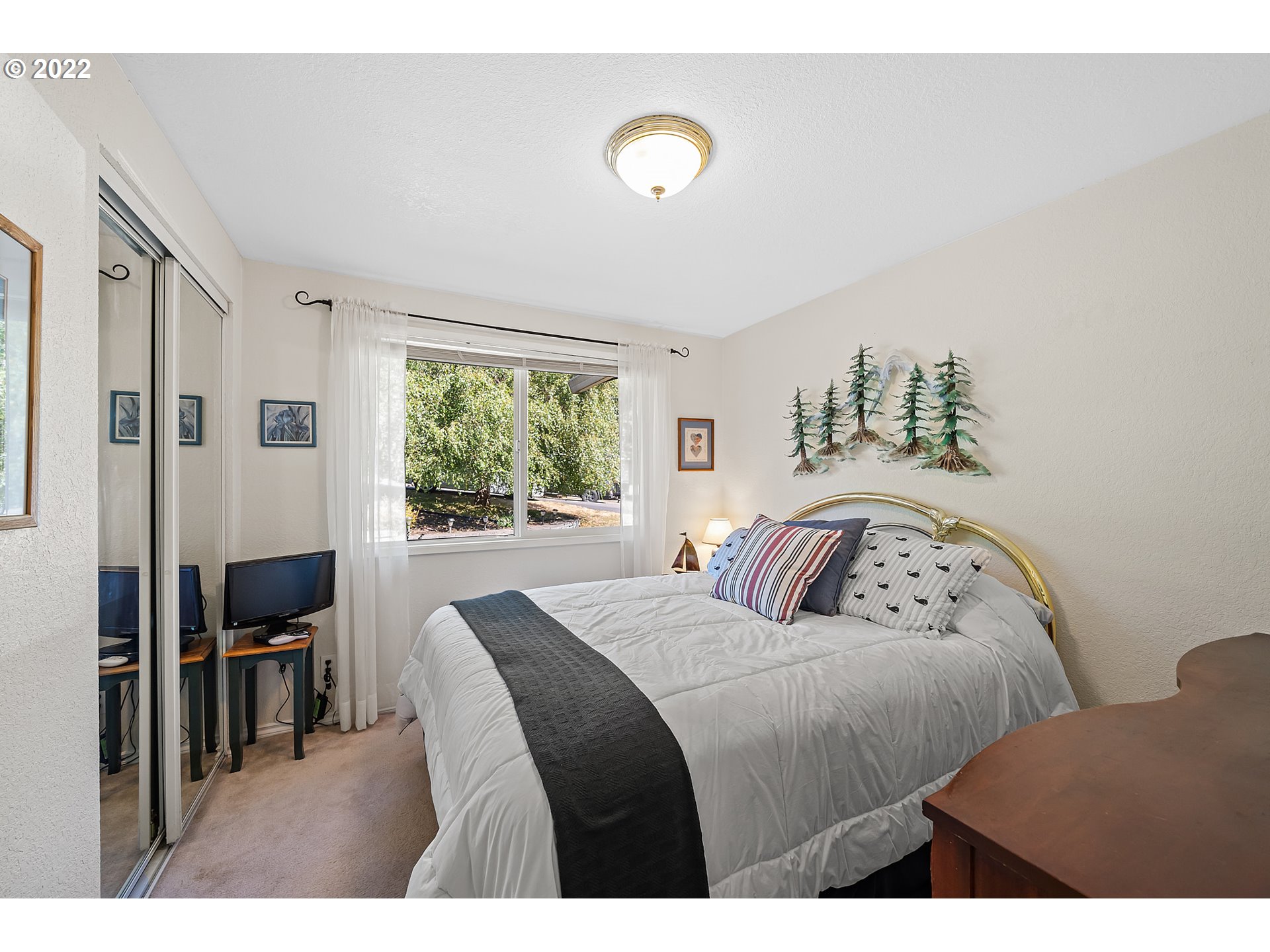 4225 Orchard Loop Netarts, OR 97141 - Photo 18 of 31 a bedroom with a bed and a lamp next to a window