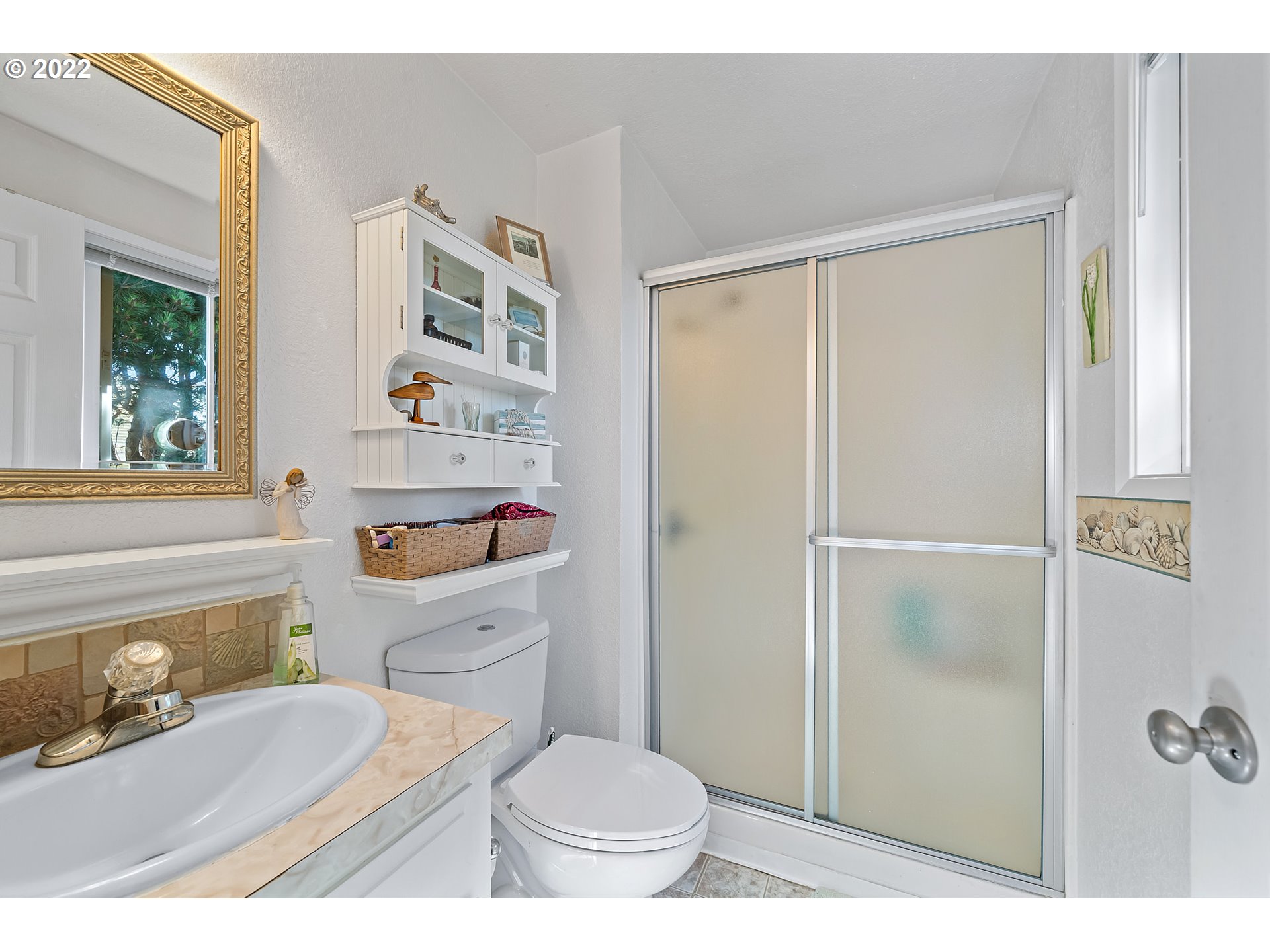 4225 Orchard Loop Netarts, OR 97141 - Photo 19 of 31 a bathroom with a sink a toilet and shower