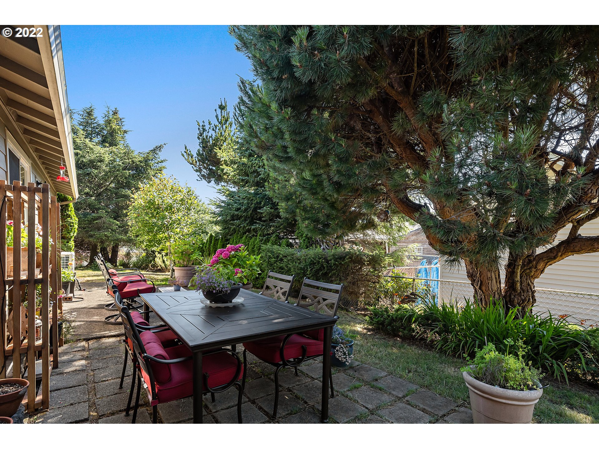 4225 Orchard Loop Netarts, OR 97141 - Photo 22 of 31 a view of a backyard with table and chairs potted plants and tree