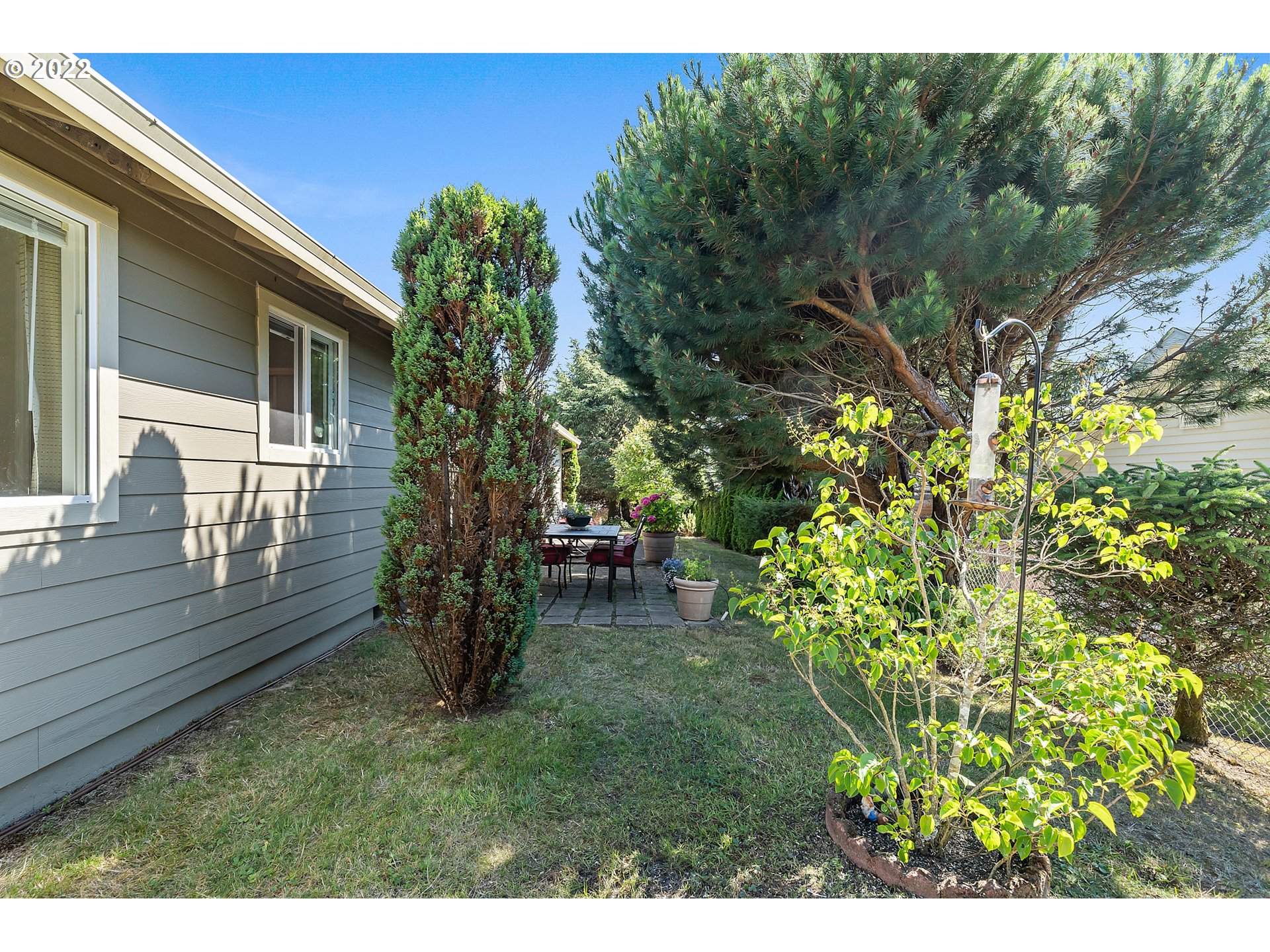 4225 Orchard Loop Netarts, OR 97141 - Photo 26 of 31 a backyard of a house with table and chairs