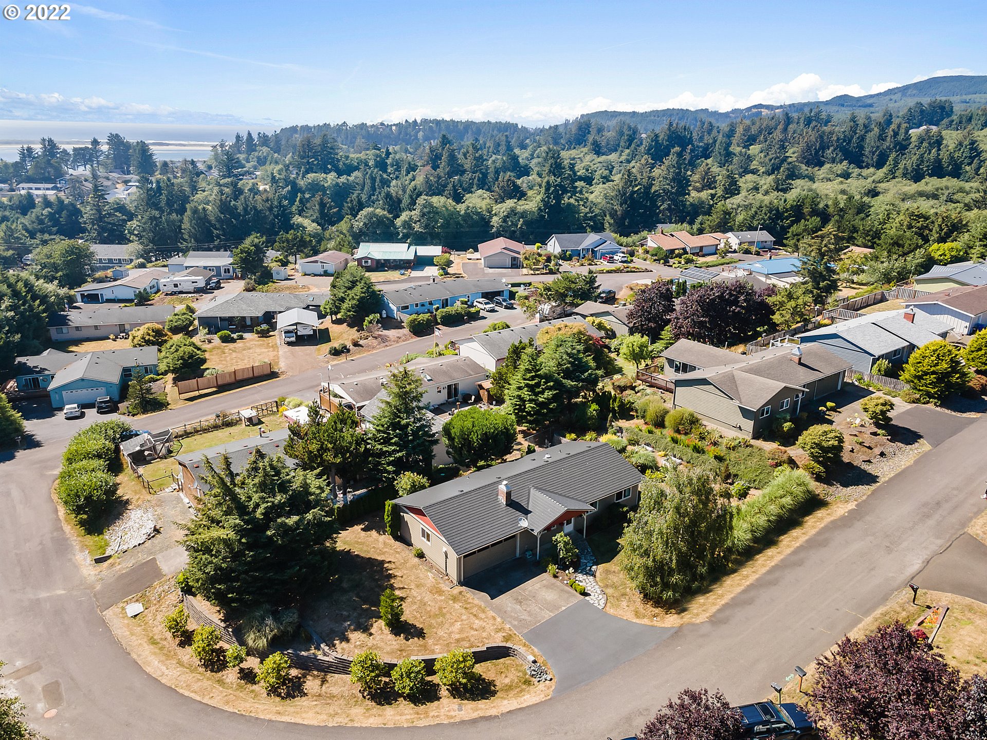 4225 Orchard Loop Netarts, OR 97141 - Photo 5 of 31 a view of a house with a yard and lake