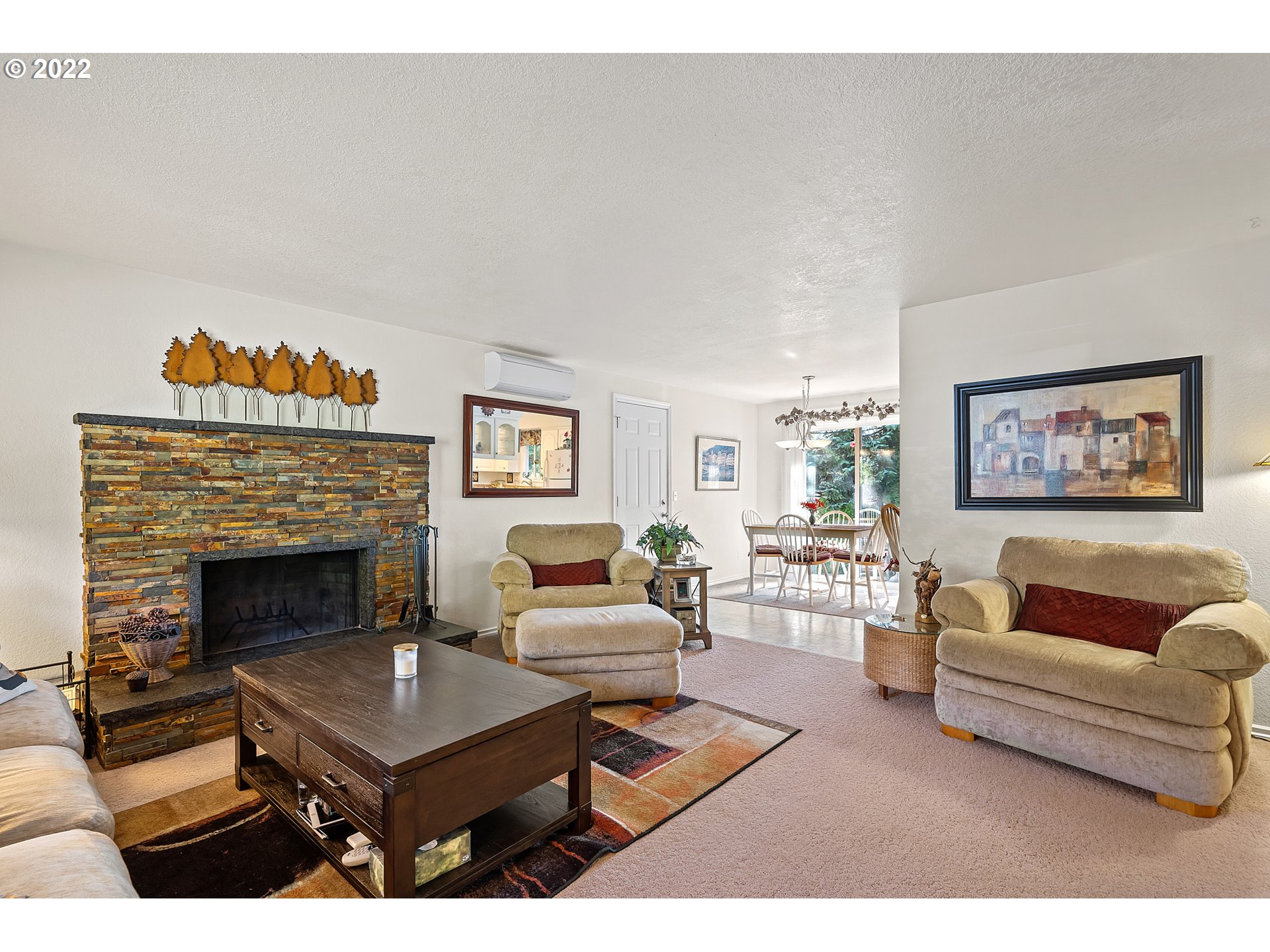 4225 Orchard Loop Netarts, OR 97141 - Photo 6 of 31 a living room with furniture a table and a fireplace