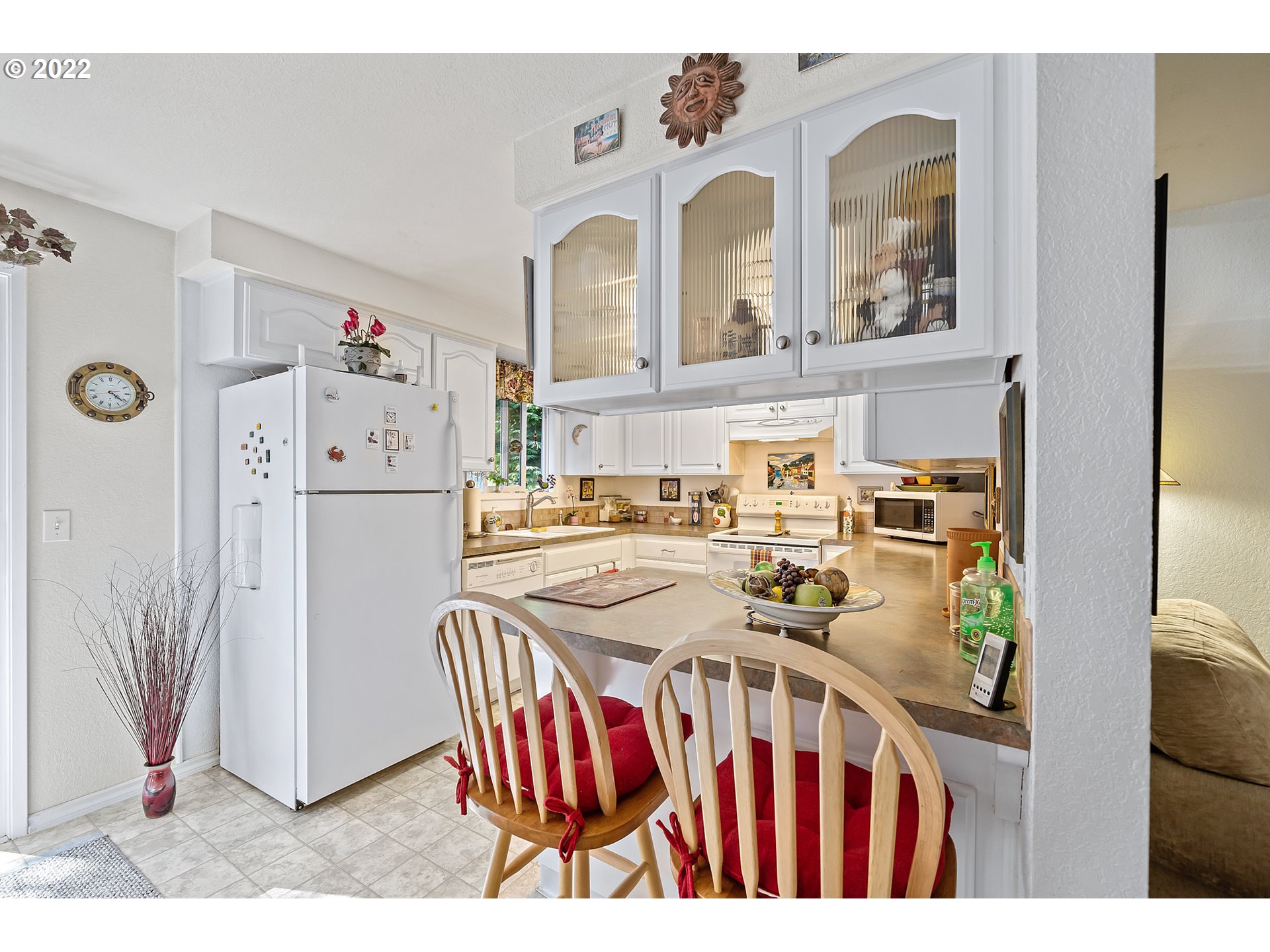 4225 Orchard Loop Netarts, OR 97141 - Photo 10 of 31 a dining room with furniture a refrigerator and kitchen view