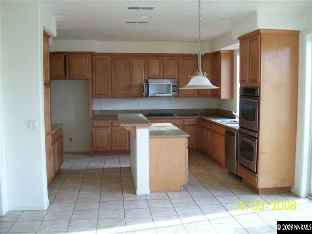 960 North University Park Loop Reno, NV 89512 - Photo 4 of 9 a kitchen with stainless steel appliances granite countertop a stove a refrigerator and a sink