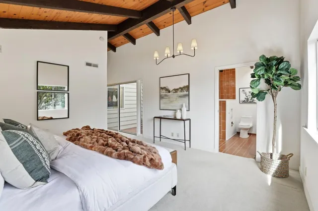 a bedroom with a bed and a table