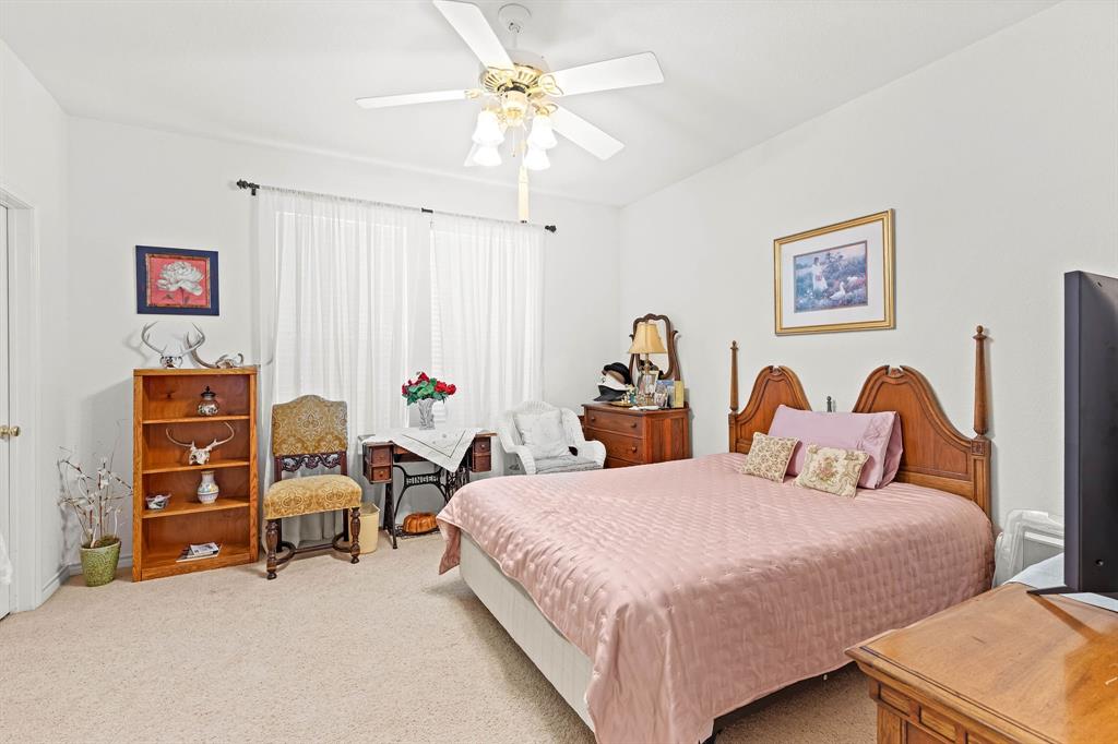 145 Indian Trail Decatur, TX 76234 - Photo 17 of 40 a bedroom with two beds and a chandelier