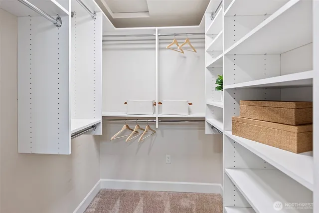 a view of walk in closet with empty racks