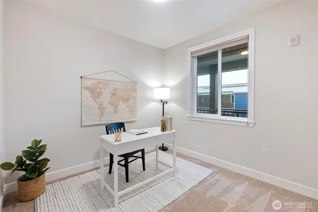 a workspace room with furniture and a window