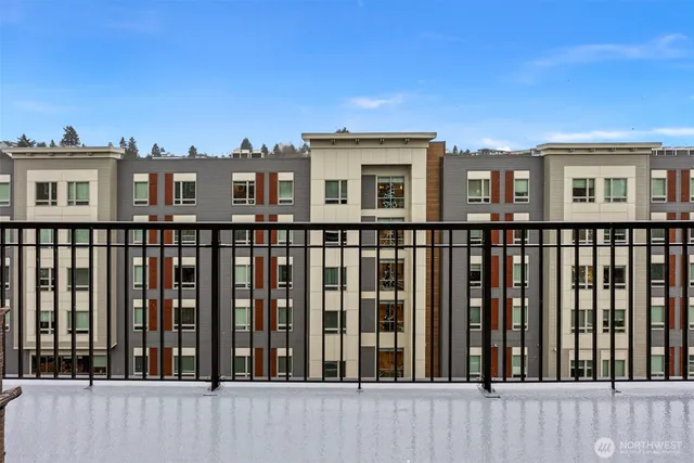 a living room with furniture fireplace and a large window